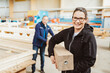© contrastwerkstatt - Happy friendly young female worker in a woodworking factory