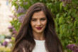 © millaf (Nemchinova) - Close-up portrait of beautiful young lady with long healthy brown hair smiling looking at camera in park in spring. Nature, people and happiness concept.