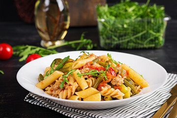 Italian pasta penne and fusilli with minced meat and vegetables. Lunch.