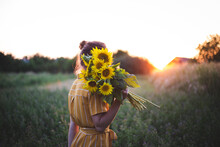 Girl And Sunflowers