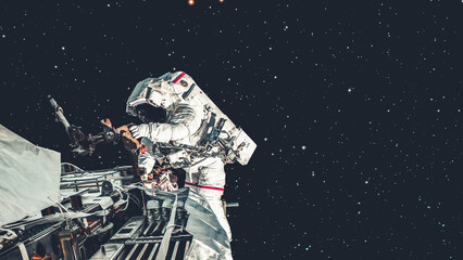 Wall Mural - Astronaut spaceman do spacewalk while working for spaceflight mission at space station . Astronaut wear full spacesuit for operation . Elements of this image furnished by NASA space astronaut photos .