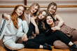 © Кирилл Горшков - Cheerful women-girls in sportswear, sitting against the wall, ready to start fitness classes, the concept of a healthy sports lifestyle. Generation Y concept