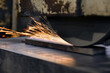 © andov - Sparks fly from the abrasive wheel when grinding and finishing metal on a surface grinder.