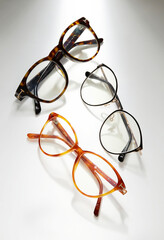 A photo of eyeglasses of different frame colors isolated on white background