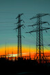 Power poles against the setting sun