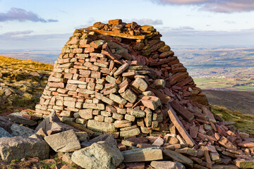 Wall Mural - A small hilltop cairn overlooking rural farmland and hills (Carn Pica, Brecon Beacons)