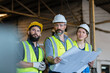 © eakgrungenerd - Industrial engineers team standing holding blueprints analyze project manufacturing metalwork in factory. Heavy Industry production concept.