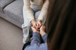 close-up of joined hands in a supportive gesture. Psychological assistance to women. Professional help of a psychologist