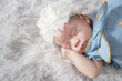 New born baby girl asian lying on a soft blanket or wool.  Cute new born baby in natural motion.Close-up portrait sleeping.