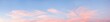 wide sky panorama with fluffy light pink cirrus clouds at sunset