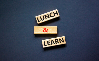 Poster - Lunch and learn symbol. Concept words Lunch and learn on wooden blocks. Beautiful black table black background. Copy space. Business, educational and lunch and learn concept.