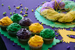 Mardi Gras cupcakes and King Cake on the table during celebration festival.