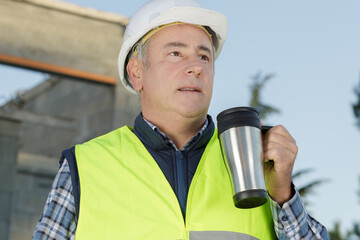 senior engineer man having coffee outdoors