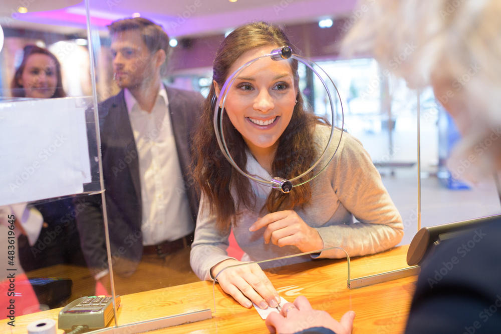 woman buying ticket in the ticket booth