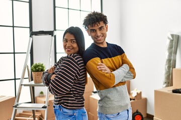 Poster - Young latin couple smiling happy standing at new home.