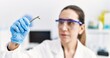 © Krakenimages.com - Young hispanic woman wearing scientist uniform using gripper at laboratory