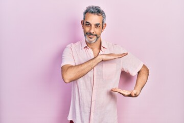 Poster - Handsome middle age man with grey hair wearing casual shirt gesturing with hands showing big and large size sign, measure symbol. smiling looking at the camera. measuring concept.