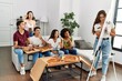 © Krakenimages.com - Group of young friends eating pizza and playing draw game at home.