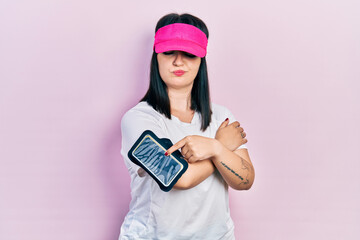 Poster - Young hispanic woman wearing sportswear skeptic and nervous, frowning upset because of problem. negative person.