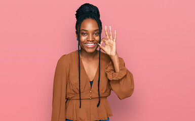 Poster - Young african american woman wearing casual clothes smiling positive doing ok sign with hand and fingers. successful expression.