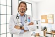 © Krakenimages.com - Middle age caucasian man wearing doctor uniform standing with arms crossed gesture al clinic