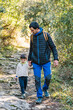 © ADDICTIVE STOCK - Father and son walking together in forest