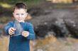 © ADDICTIVE STOCK - Little boy with piece of ice in forest
