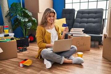 Sticker - Young blonde woman smiling confident using laptop and credit card at new home