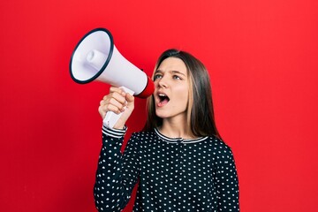 Wall Mural - Young teenager girl shouthing and screaming with megaphone