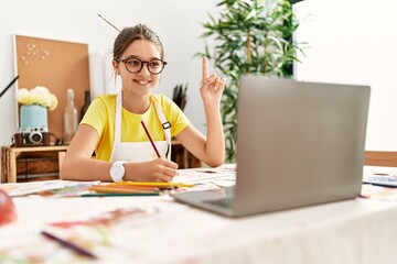 adorable girl smiling confident having online draw lesson at art studio