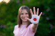© Svetlana - Kid girl show stop gesture with hands painted in Japan flag colors. Reopen school, Healthcare. Education abroad. Learn Japanese. Selective focus