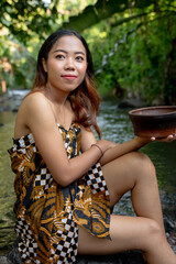 Wall Mural - Portrait of young girl in river, woman posing on the water 