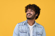 © insta_photos - Happy joyful smiling young indian man looking aside up thinking of new good opportunities, dreaming, feeling inspired and proud standing isolated on yellow background. Portrait