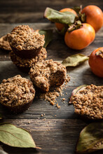 Persimmon Muffins In A Rustic Kitchen, With Fresh Persimmons