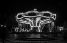 The Carousel Moving At Night Time. Black And White