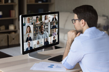 Wall Mural - focused young businessman holding video conference call with motivated diverse colleagues and africa
