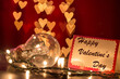 Happy Valentine's day writing on card with light bulb on heart shaped bokeh lights background
