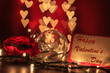 Happy Valentine's day writing on card with light bulb and rose on heart shaped bokeh lights background