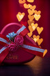 Heart shaped gift box with rose on heart shaped bokeh lights background