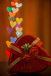 Heart shaped gift box with rose on heart shaped colorful bokeh lights background