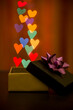 Open gift package with heart shaped bokeh lights