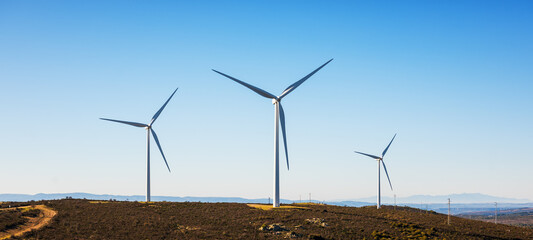 Wall Mural - wind turbines on a beautiful blue sky in a mountain wind farm in sardinia. renewable energy concept,