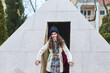 A girl stands at a replica of the Egyptian pyramid in the miniature park. Travel and tourism.