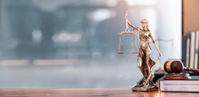 Legal And Law Concept. Statue Of Lady Justice With Scales Of Justice And Wooden Judge Gavel On Wooden Table. Panoramic Image Statue Of Lady Justice.