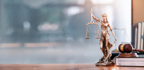 legal and law concept. statue of lady justice with scales of justice and wooden judge gavel on woode