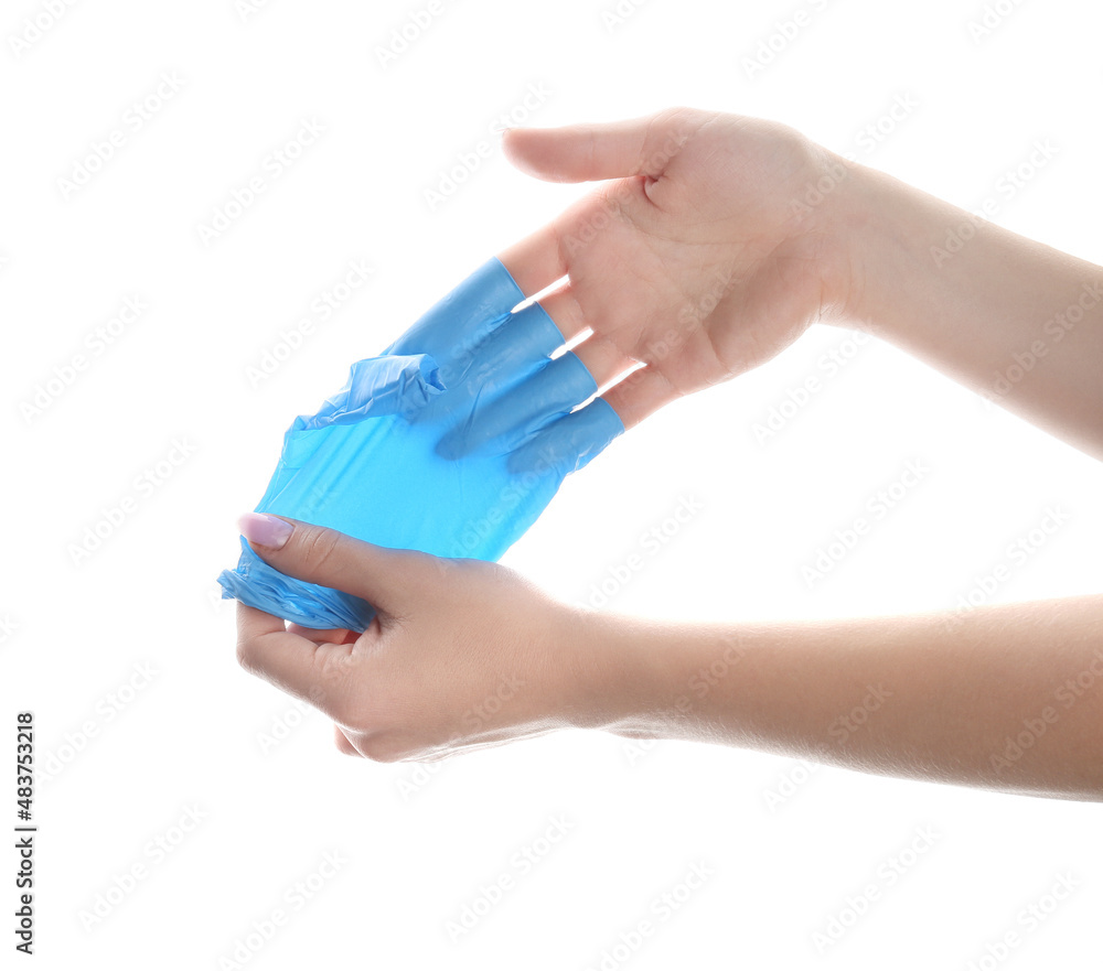 Woman taking off medical glove on white background