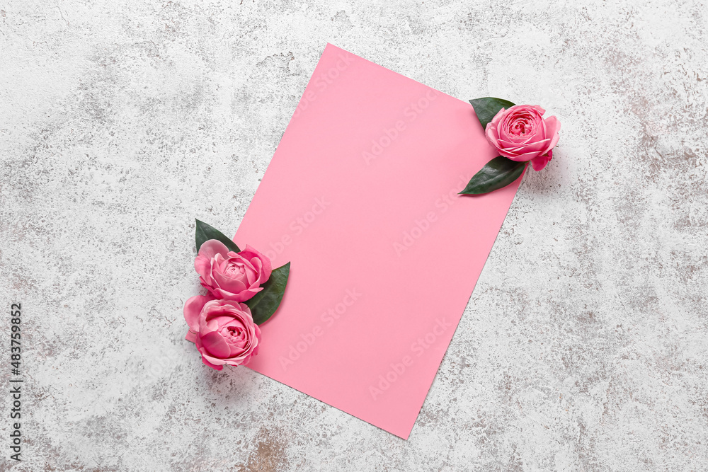 Blank card and beautiful rose flowers on light background