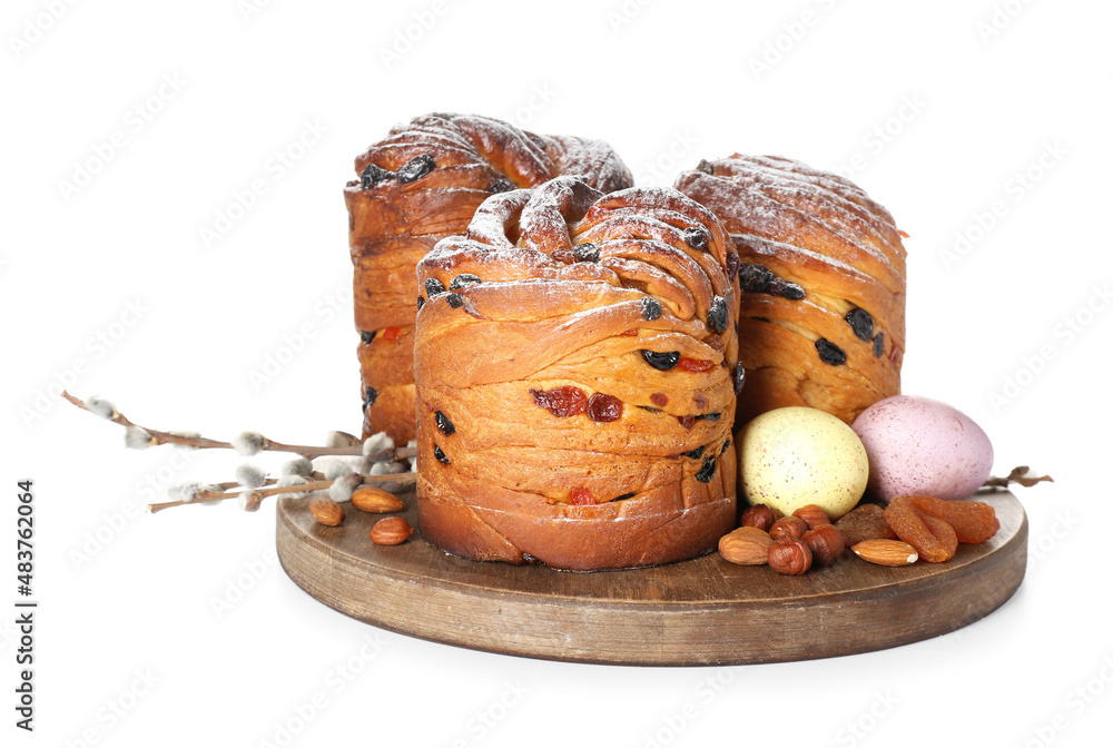 Wooden board with delicious Easter cake, pussy willow branches and eggs on white background
