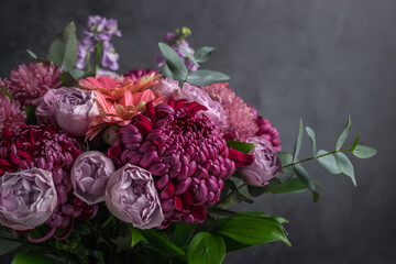 Flower arrangement of chrysanthemums and roses on dark background. Greeting card, invitation concept. copy space for text