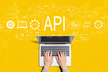 API - application programming interface concept with person using a laptop computer